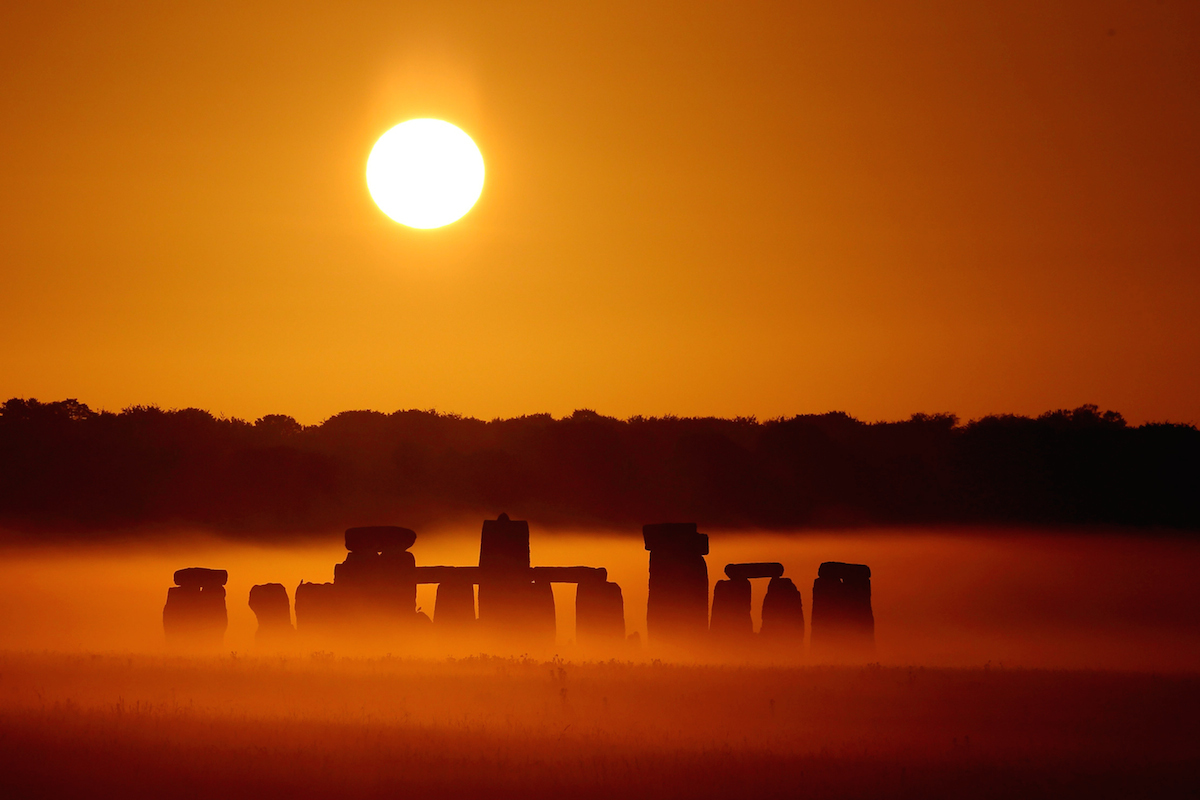 SWNS Pictures of the Year 2015 - One hundred of the most compelling images on the SWNS wire this year as chosen by our picture editors.The sun rises over Salisbury Plain as it's light illuminates the mist shrouding Stonehenge, Wiltshire, July 7 2015. Amateur photographer Robin Morrison made half a dozen visits to the ancient megalith, travelling over a hundred miles each time, to capture the precise lighting conditions he wanted. The normal weather patterns in the UK mean that a clear sky just a few minutes after sunrise is uncommon - a clear sky at sunrise combined with a misty morning is an extremely rare occurrence.