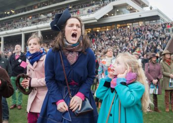 SWNS Pictures of the Year 2015 - One hundred of the most compelling images on the SWNS wire this year as chosen by our picture editors.(Left - right) Amelia Tinkler, 9, niece of jockey Andrew Tinkler, Sophie Burkin, 25, and Daisy Tinkler, 6, react whilst watching racing on Ladies Day at Cheltenham Festival. Cheltenham Racecourse, Cheltenham, England. March 11 2015.