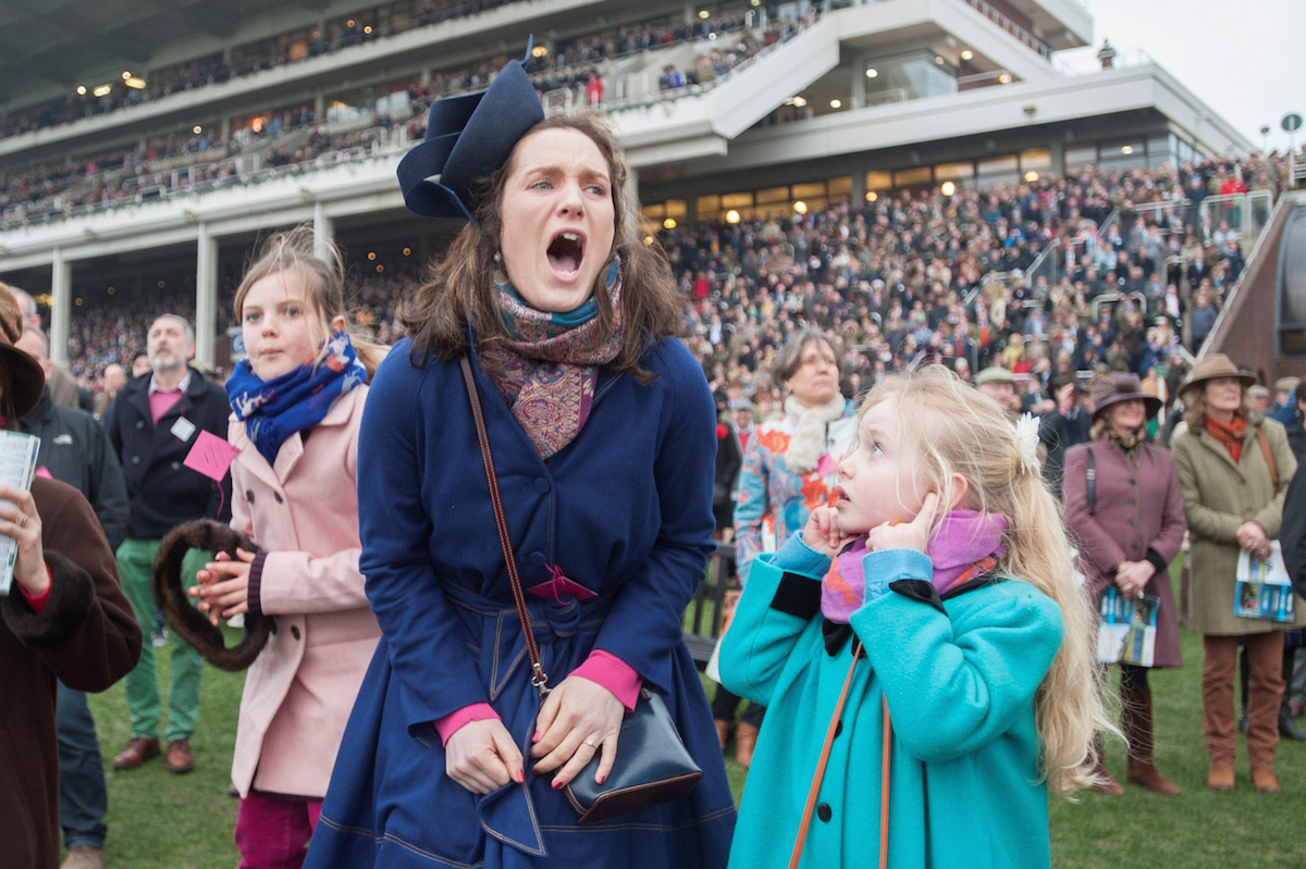 SWNS Pictures of the Year 2015 - One hundred of the most compelling images on the SWNS wire this year as chosen by our picture editors.(Left - right) Amelia Tinkler, 9, niece of jockey Andrew Tinkler, Sophie Burkin, 25, and Daisy Tinkler, 6, react whilst watching racing on Ladies Day at Cheltenham Festival. Cheltenham Racecourse, Cheltenham, England. March 11 2015.