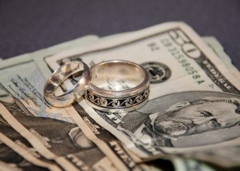 Weddings rings and large bills of money