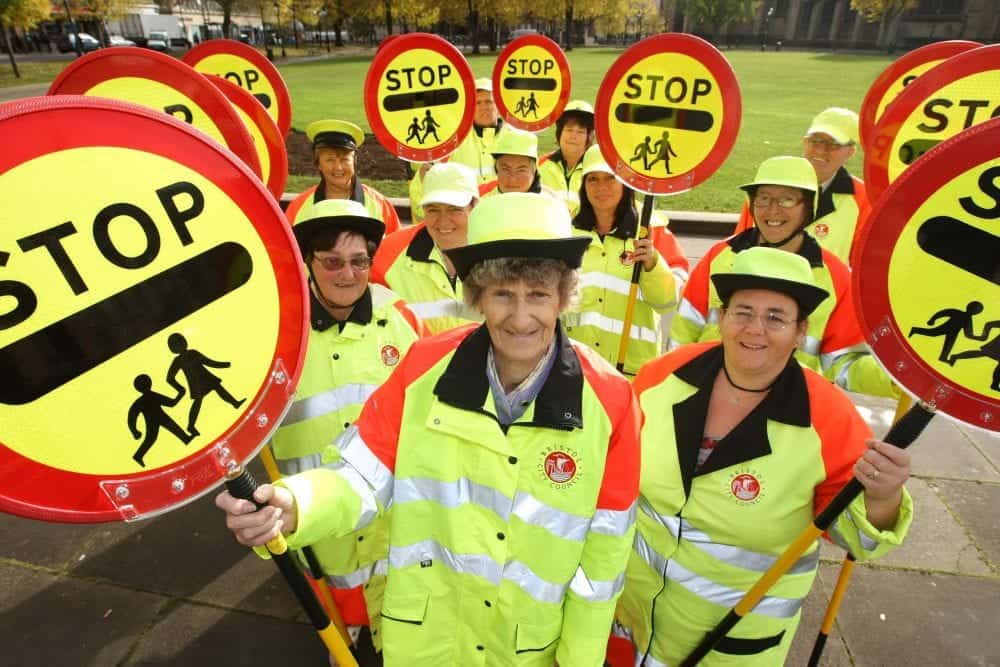 Stock photo of Bristol's school crossing patrol people. See SWNS story SWCROSS; A council could become the first in Britain to scrap ALL lollipop ladies and men - as the popular crossing guards face the axe across the country. Cash-strapped Bristol City Council plans to ditch the patrol staff at 80 schools in a bid to slash £360,000 off its budget. But the authority has been warned by a furious school governor that axing all 67 lollipop people will lead to more children being hurt in accidents on busy city roads. In its impact report, the council even admits cutting the school patrols will impact on the safety of children - with each child's life being priced at £4,500.