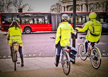 Cyclists in London staying safe by wearing high-visibility jackets. (Taken using my mobile phone.)