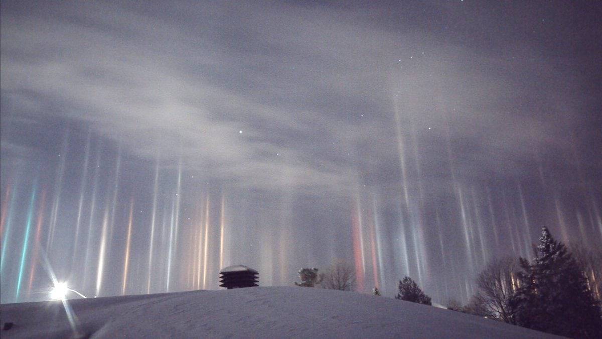 A father captured these stunning images of multicolored pillars beaming down from the sky after waking up at 1.30am and thinking  ALIENS were invading. See SWNS story SWLIGHT; Timothy Joseph Elzinga, 33, got out of bed when two-year-old son Gibson started crying - and he noticed the incredible light show outside. He thought someone from Star Wars was ''trying to beam people up'' - and quickly ran outside to investigate the yellow, green, red and blue lights. The amateur photographer captured the incredible light pillars - caused by crystals of moisture frozen in the air - reflecting light over Ontario, Canada, last Friday.