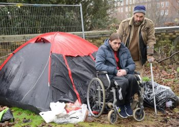 Homeless Jonathan Martin and Chris Stanford who are living in a tent in Chatham. See National News story NNTRAMP; A pair of homeless men have set up camp in a graveyard to escape the abuse they receive on the streets - which they describe as "the jungle". Chris Stanford and Jonathon Martin said they have had things thrown at them, been spat at - and mean-spirited locals have even tried to wee on them. Each day Chris, who uses crutches, helps Jon, who is paraplegic, into his wheelchair and the pair head to the high street in Chatham, Kent, to beg for change. Jon, 38, said he needs a wound on his foot dressed says the district nursing team refuses to visit him because he has no fixed address. *** Local Caption ***
Homeless Jonathan Martin and Chris Stanford who are living in a tent in Chatham. See National News story NNTRAMP; A pair of homeless men have set up camp in a graveyard to escape the abuse they receive on the streets - which they describe as "the jungle". Chris Stanford and Jonathon Martin said they have had things thrown at them, been spat at - and mean-spirited locals have even tried to wee on them. Each day Chris, who uses crutches, helps Jon, who is paraplegic, into his wheelchair and the pair head to the high street in Chatham, Kent, to beg for change. Jon, 38, said he needs a wound on his foot dressed says the district nursing team refuses to visit him because he has no fixed address.