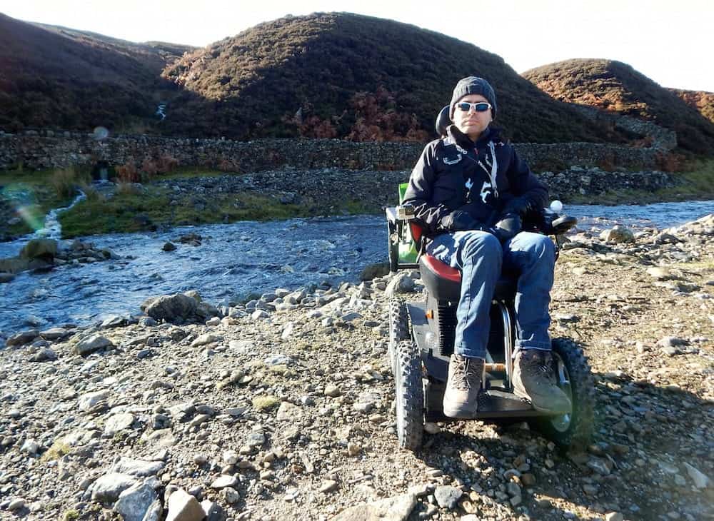 Jason Liversidge from Hull, East Yorks preparing for his latest challenge.  He says motor neurone disease is killing him, but wheelchair-bound Jason Liversidge will not let the condition stop him tackling mountains and other challenges.  See ROSS PARRY story RPYCLIMB.  With the help of his all-terrain 4x4 wheelchair, the Holderness dad of two aims to climb the highest mountain in Wales, Mount Snowdon.  Mr Liversidge, 41, is taking on the challenge in a bid to raise £5,000 for Marie Curie Nurses and the Dove House Hospice, Hull.  After being diagnosed with the muscle-wasting disease in 2013, Mr Liversidge, 41, from Rise, near Skirlaugh, has lost the ability to move.  But the self-confessed adrenaline junkie has not let his condition get in the way of his passion for excitement.  He has taken on the longest zip line in Europe at speeds in excess of 100mph, parasailed in Turkey and driven at Silverstone in a Formula One-style racing car.  After an online funding campaign to acquire a 4x4 wheelchair, he is now preparing to take on Mt Snowdon on Tuesday, July 18.