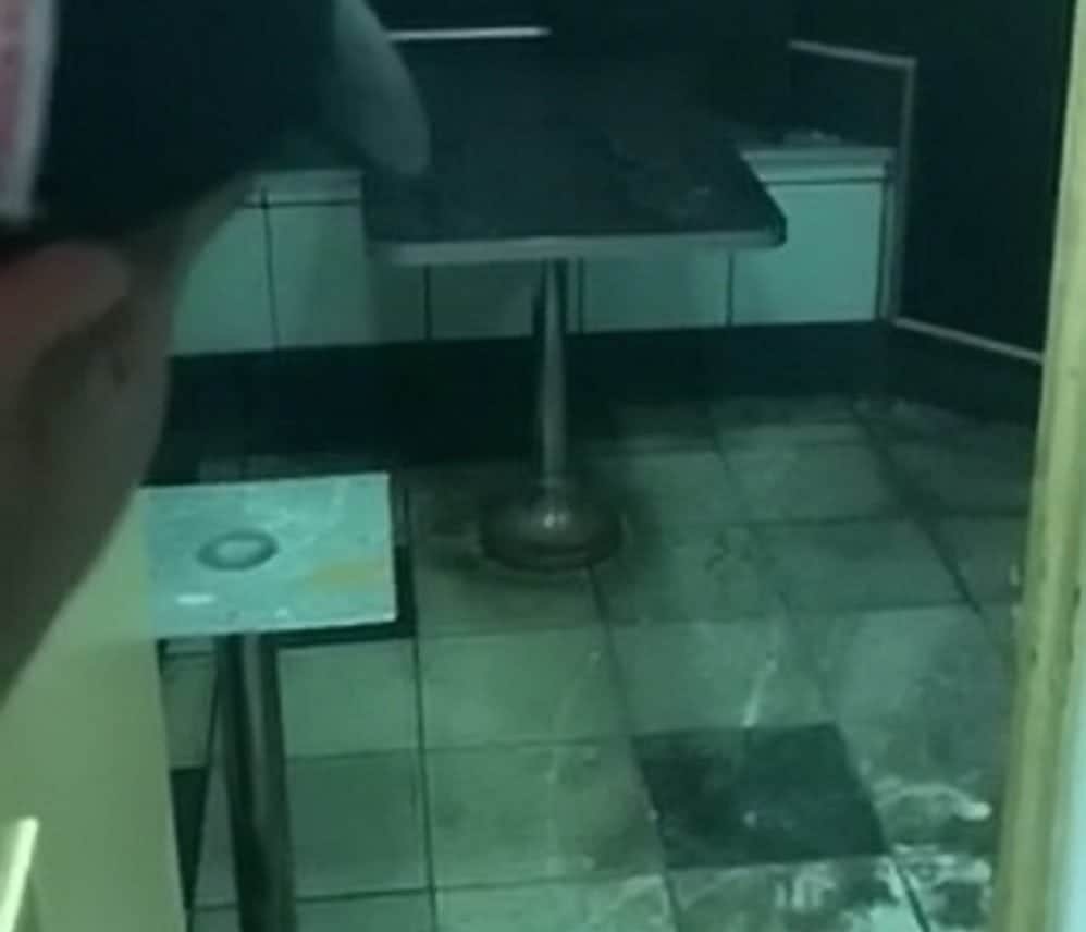 Shocking footage show what appears to be human waste on the floor of a west London Burger King branch after localised flooding covered the tiles in a thick brown sludge. See story SWBURGER. Two videos, taken by an outraged customer, show the filthy downstairs area of the Burger King branch in Gloucester Road just after 10pm on 8 August. But when the customer complained to a member of staff and pointed out the revolting conditions - he was told to leave the eatery. The customer, who has asked to remain anonymous, discovered the revolting room when he and two friends tried to find the toilets at the fast food joint. The footage shows the customer walking through the disgusting downstairs area pointing out what appears to be an open hole in the basement of the restaurant. The customer stares down the hole and announces it is "the sewer" to his friend who was filming the shocking conditions at the fast food joint.