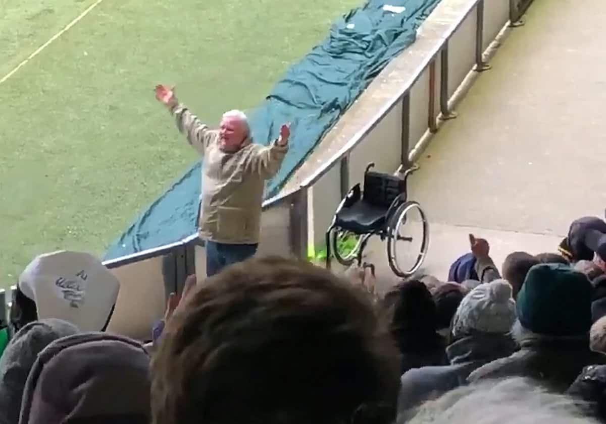 This video shows the moment a football supporter had a real-life Little Britain moment - when he rose from his wheelchair to start celebrating. See SWNS story SWFAN; Sports reporter Jak Ball filmed the fan wheeling his chair up and down the side of the pitch before he stunned the crowd by jumping out of it in delight and waving his arms aloft. The 'miracle' was reminiscent of the Little Britain TV show, where the character Andy Pipkin feigns the need for a wheelchair to his carer, Lou Todd! It is not known what disabilities the supporter may suffer, but Jak, who works for the Plymouth Herald, said he couldn't believe what he was seeing.