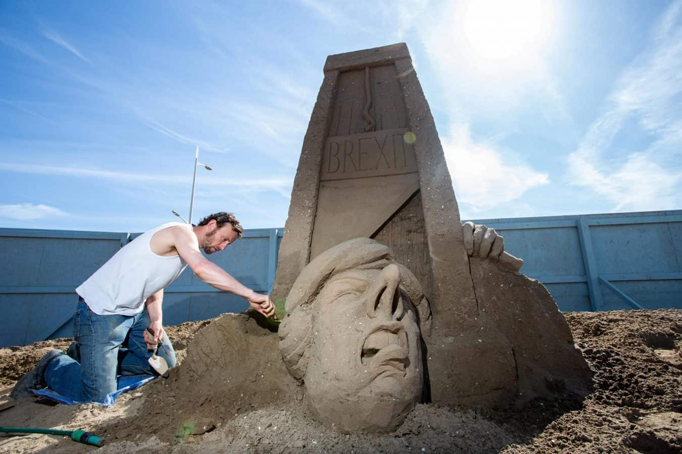 Sand artist creates giant sculpture of Theresa May losing her head ...