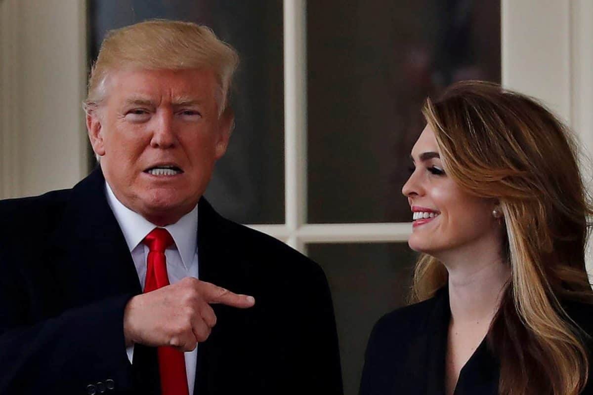 FILE PHOTO: U.S. President Donald Trump reacts as he stands next to former White House Communications Director Hope Hicks outside of the Oval Office as he departs the White House for a trip to Cleveland, Ohio, in Washington D.C., U.S., March 29, 2018. REUTERS/Carlos Barria/File Photo