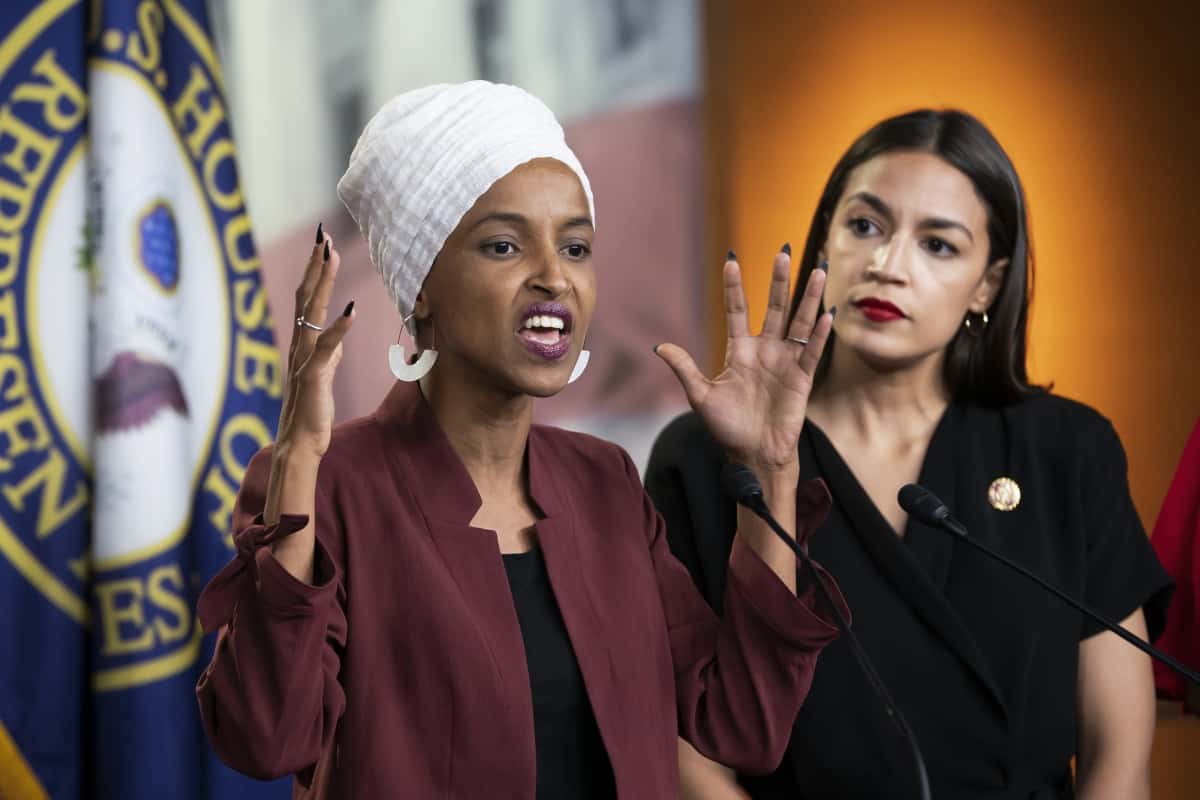 U.S. Rep. Ilhan Omar, D-Minn., left, joined at right by U.S. Rep. Alexandria Ocasio-Cortez, D-N.Y., responds to base remarks by President Donald Trump after he called for four Democratic congresswomen of color to go back to their "broken" countries, as he exploited the nation's glaring racial divisions once again for political gain, during a news conference at the Capitol in Washington, Monday, July 15, 2019. All four congresswomen are American citizens and three of the four were born in the U.S. Omar is the first Somali-American in Congress. (AP Photo/J. Scott Applewhite)