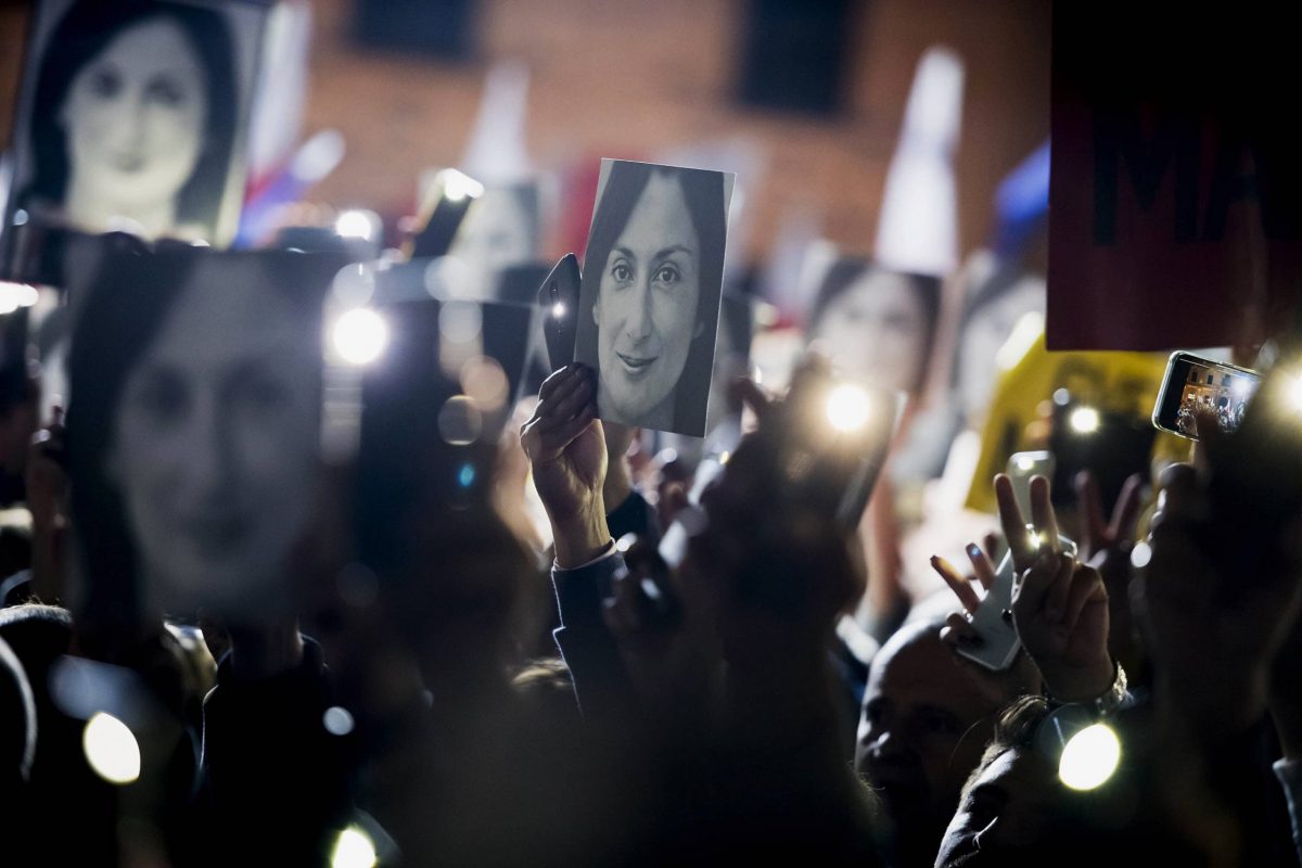 People hold pictures of slain journalist Daphne Caruana Galizia as they protest outside the office of the Maltese Prime Minister Joseph Muscat, calling for the resignation of Muscat, in Valletta, Malta., Friday, Nov. 29, 2019. The family of the journalist who was killed by a car bomb in Malta is urging Muscat to resign, after his former chief aide was released from jail in a probe aimed at finding the mastermind of the 2017 murder. (AP Photo/Rene Rossignaud)