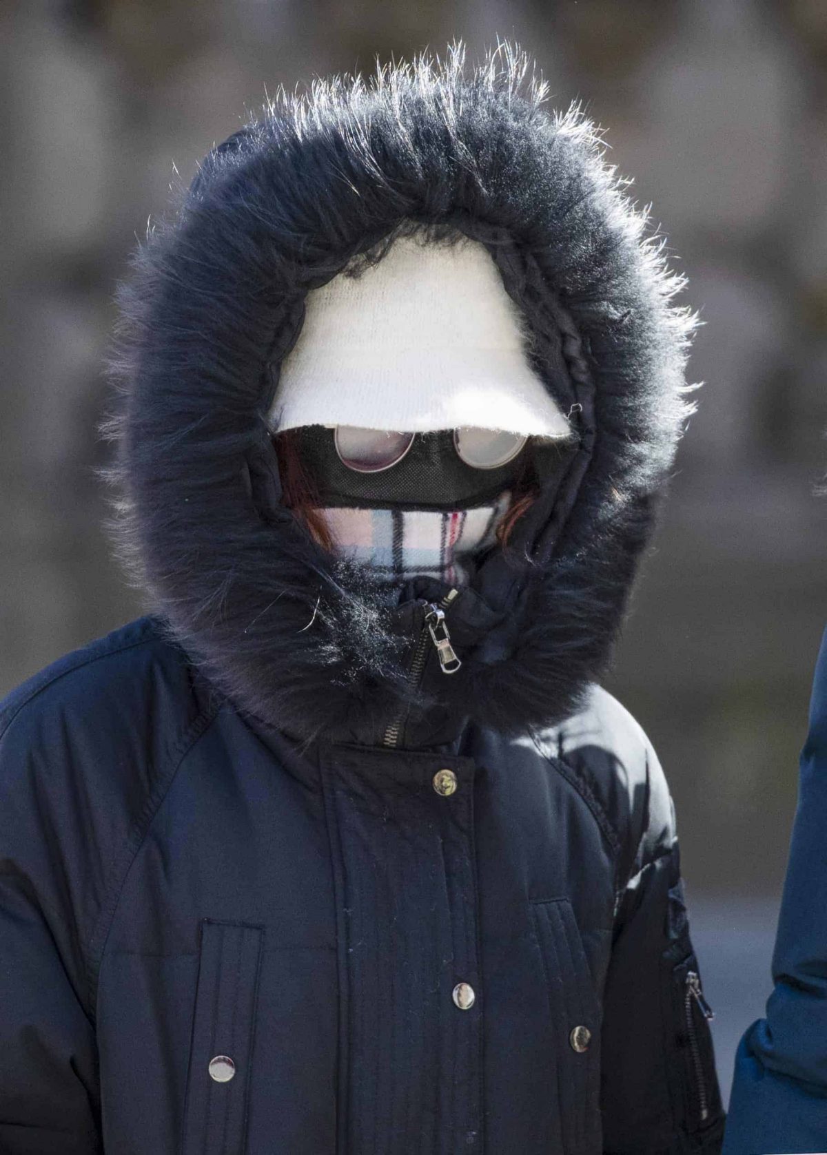 A woman wearing a protective face mask walks along the Royal Mile, Edinburgh, as the Government's top scientist warmed that up to 10,000 people in the UK are already infected.