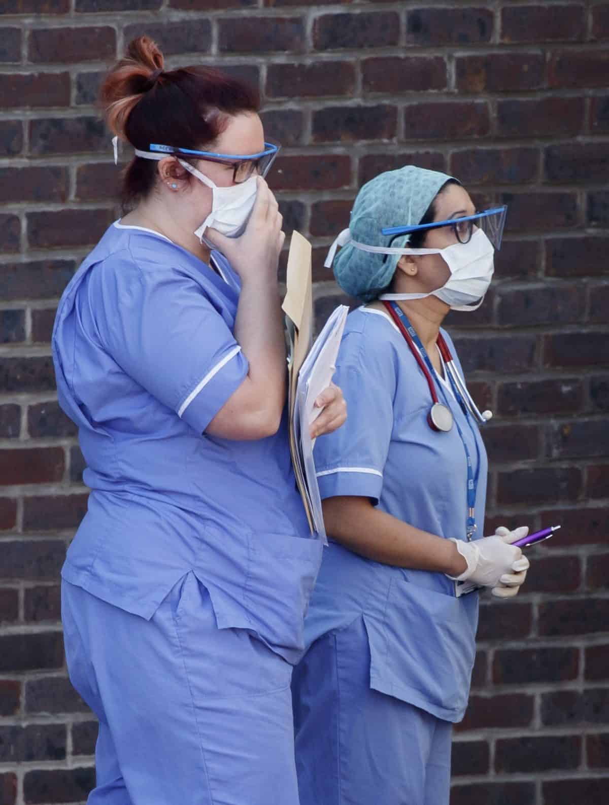 Hospital staff wear face masks outside Doncaster Royal Infirmary, as organisations representing hospital trusts have rounded on the Government over its promise of more personal protective equipment (PPE) to protect workers in the fight against Covid-19.