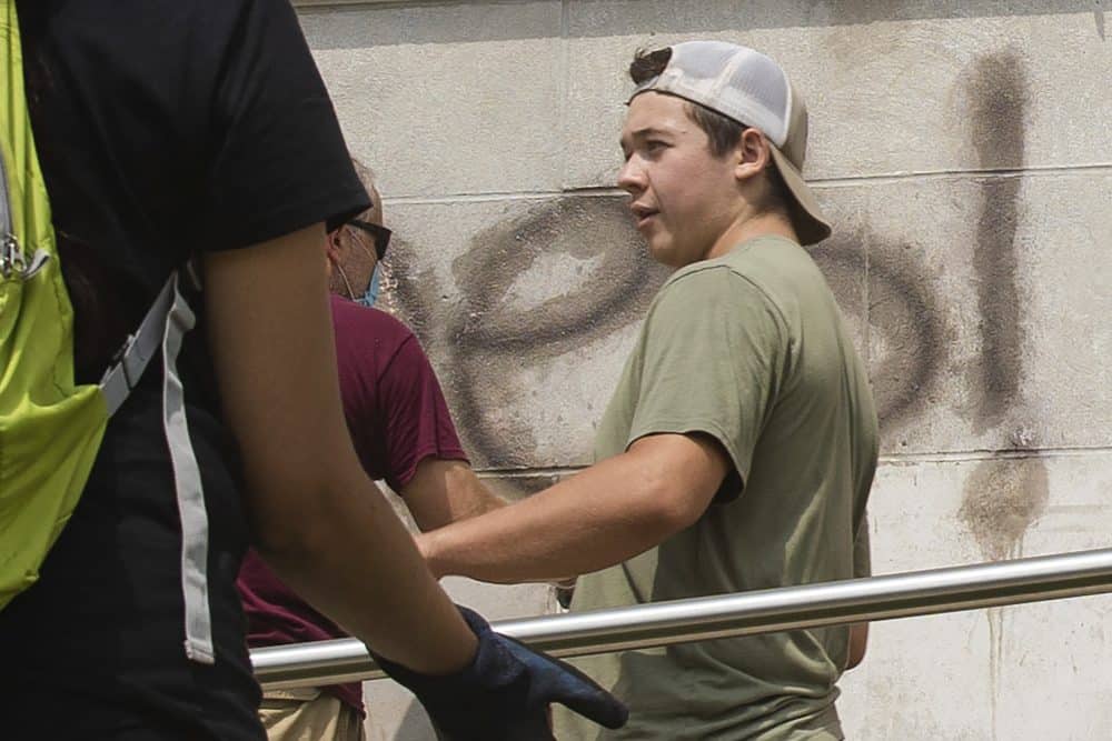 Kyle Rittenhouse helps clean the exterior of Reuther Central High School in Kenosha, Wis., on Tuesday, Aug. 25, 2020. Rittenhouse, 17, was arrested Wednesday, Aug. 26, after two people were shot to death during protests in Kenosha over the police shooting of Jacob Blake. (Pat Nabong/Chicago Sun-Times via AP)