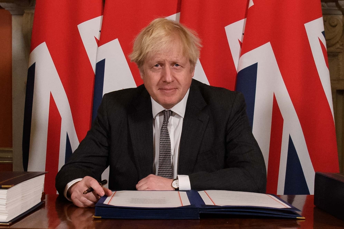 Prime Minister Boris Johnson signs the EU-UK Trade and Cooperation Agreement at 10 Downing Street, Westminster.