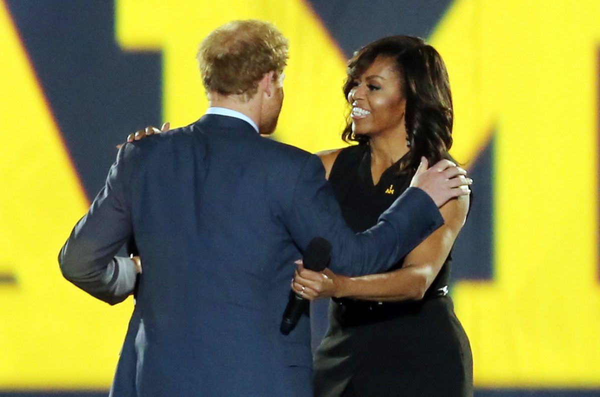 Prince Harry welcomes First Lady Michelle Obama onto the stage during the opening ceremony of the Invictus Games 2016 held at ESPN Wide World of Sports in Orlando, Florida.