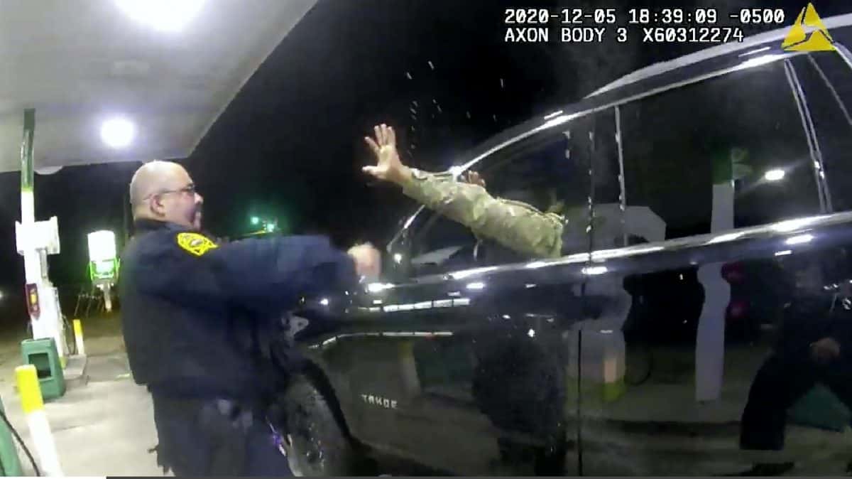 In this image made from Windsor, (Va.) Police video, A police officer uses a spray agent on Caron Nazario on Dec. 20, 2020, in Windsor, Va. Nazario, a second lieutenant in the U.S. Army, is suing two Virginia police officers over a traffic stop during which he says the officers drew their guns and pointed them at him as he was dressed in uniform. Caron Nazario says his constitutional rights were violated by the traffic stop in the town of Windsor in December. (Windsor Police via AP)