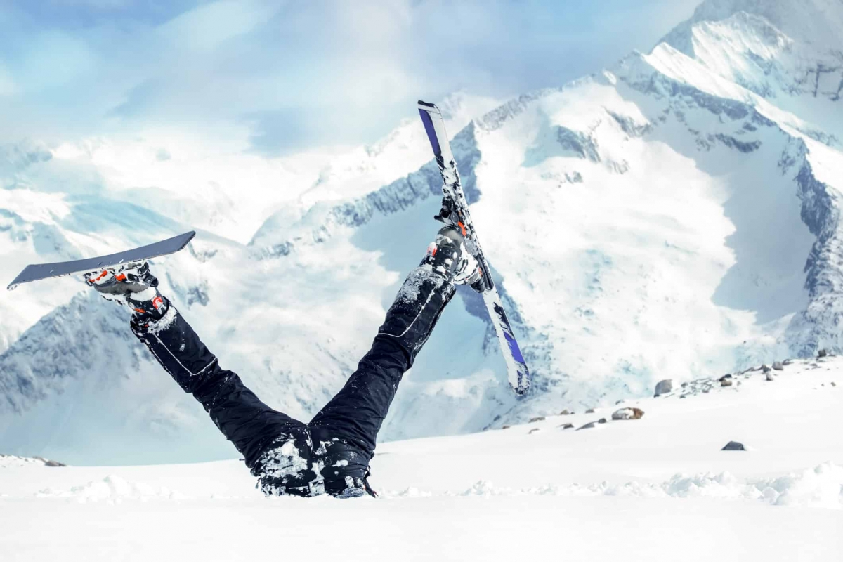 Newbie skier stuck  in deep snow with his legs upside down