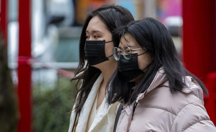 Members of the Chinese community in Manchester wearing face masks. The Government's Cobra committee is meeting in Downing Street to discuss the threat to the UK from coronavirus.
