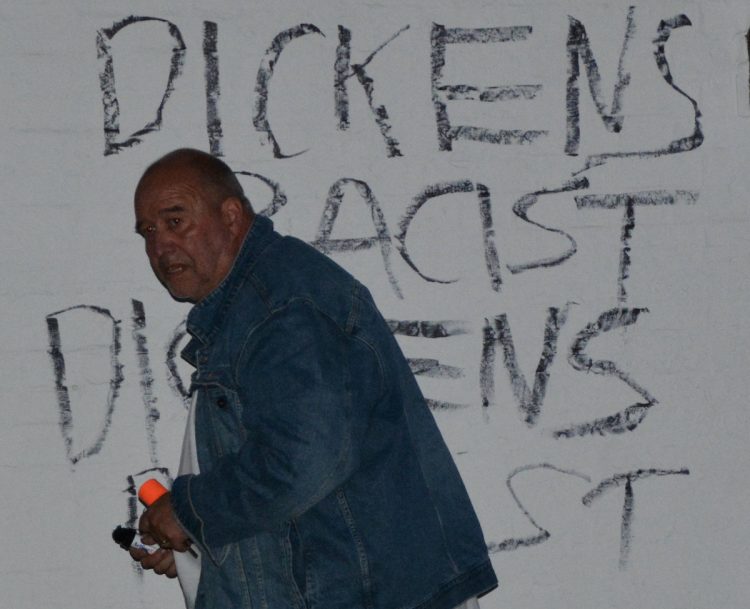 Ian Driver with the graffiti he wrote.Credit;SWNS