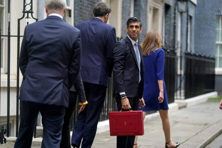 Chancellor of the Exchequer Rishi Sunak holds his ministerial 'Red Box' as he stands with his ministerial team and Parliamentary Private Secretaries, outside 11 Downing Street, London, before delivering his Budget to the House of Commons. Picture date: Wednesday October 27, 2021.