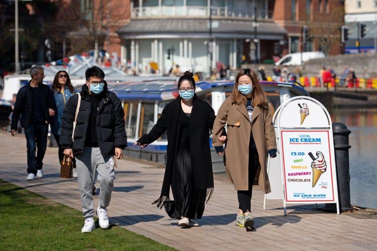 File photo dated 04/04/21 of people wearing protective face masks walking in Stratford-upon-Avon in Warwickshire. Scientists are calling for 3,000 long Covid sufferers of all ages, genders and ethnicities to help them establish a possible genetic link to the virus. Issue date: Wednesday September 1, 2021.