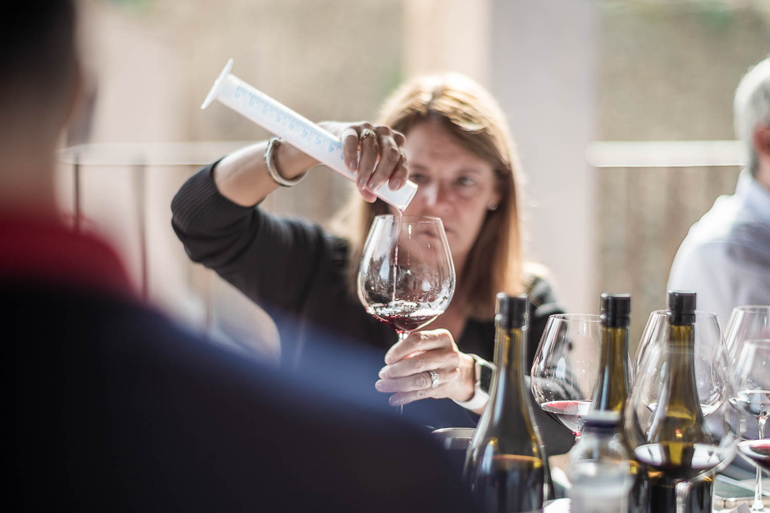 A Vines member blending their own wine